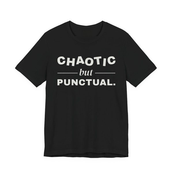 Black t-shirt printed in off-white ink with “Chaotic” in wobbly capitals, a calm italic “but”, and “Punctual.” squared away underneath