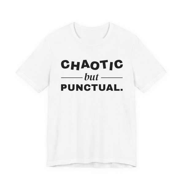 White t-shirt printed in dark ink with “Chaotic” in wobbly capitals, a calm italic “but”, and “Punctual.” squared away underneath