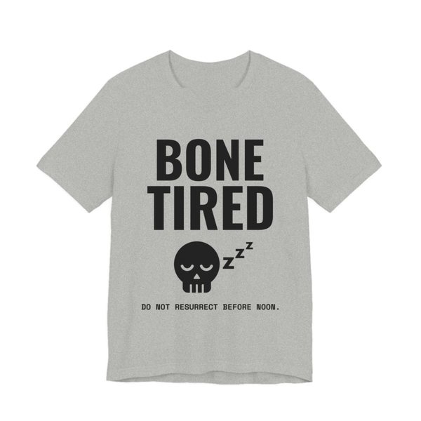 Athletic Heather t-shirt printed in dark ink with “Bone Tired” above a sleeping skull with little z's, and “Do not resurrect before noon.”