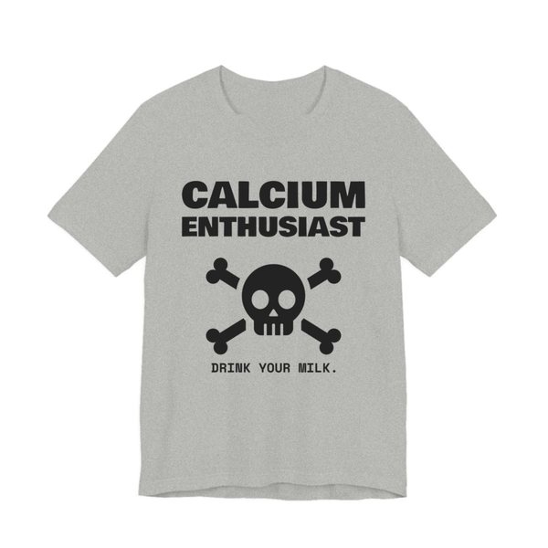 Athletic Heather t-shirt printed in dark ink with “Calcium Enthusiast” above a skull and crossbones, with “Drink your milk.”
