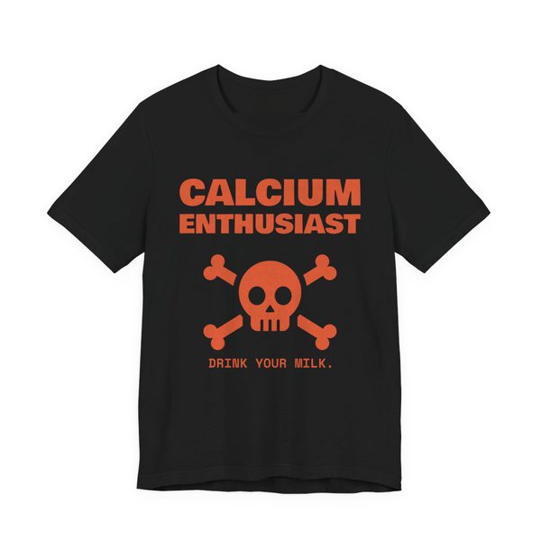Black t-shirt printed in orange ink with “Calcium Enthusiast” above a skull and crossbones, with “Drink your milk.”