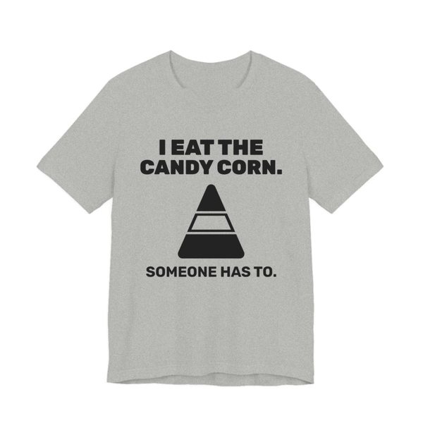 Athletic Heather t-shirt printed in dark ink with “I Eat the Candy Corn.” above a big candy corn, with “Someone has to.”