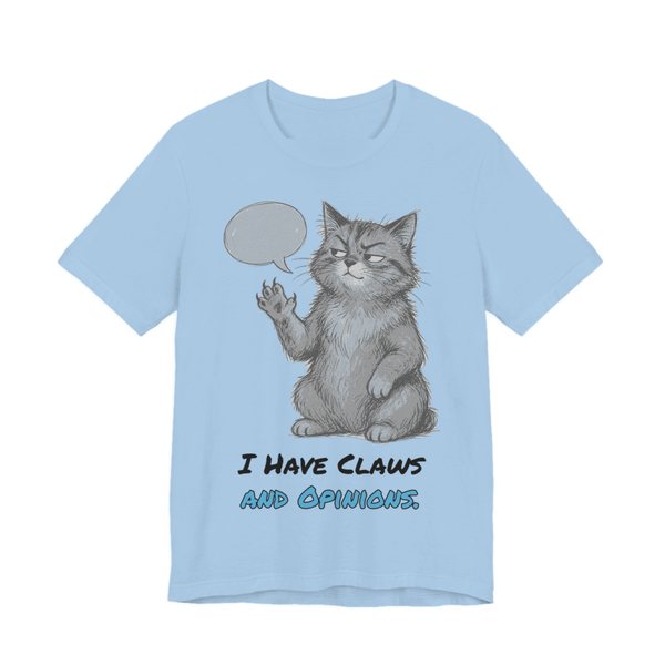 Baby Blue t-shirt printed in full-color print with a full-color pencil drawing of a cat with a speech bubble, holding up one paw and the words “I Have Claws and Opinions.”