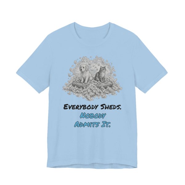 Baby Blue t-shirt printed in full-color print with a full-color pencil drawing of a puppy and a kitten sitting in a pile of fur and the words “Everybody Sheds. Nobody Admits It.”