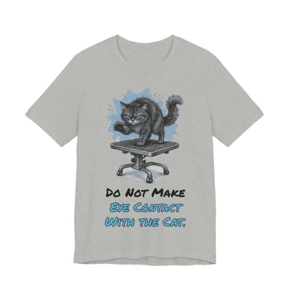 Athletic Heather t-shirt printed in full-color print with a full-color pencil drawing of an angry cat on a grooming table and the words “Do Not Make Eye Contact With the Cat.”