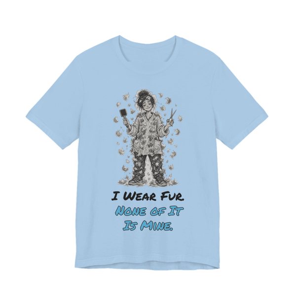 Baby Blue t-shirt printed in full-color print with a full-color pencil drawing of a groomer covered head to toe in pet fur, holding a brush and scissors and the words “I Wear Fur. None of It Is Mine.”