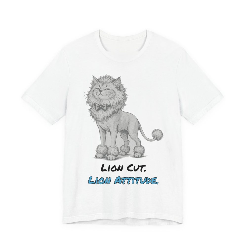 White t-shirt printed in full-color print with a full-color pencil drawing of a cat with a lion cut, a bow tie and a pom-pom tail and the words “Lion Cut. Lion Attitude.”