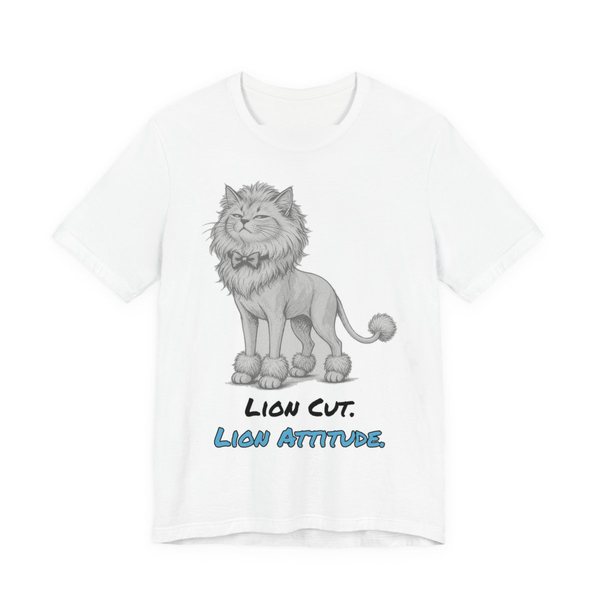 White t-shirt printed in full-color print with a full-color pencil drawing of a cat with a lion cut, a bow tie and a pom-pom tail and the words “Lion Cut. Lion Attitude.”