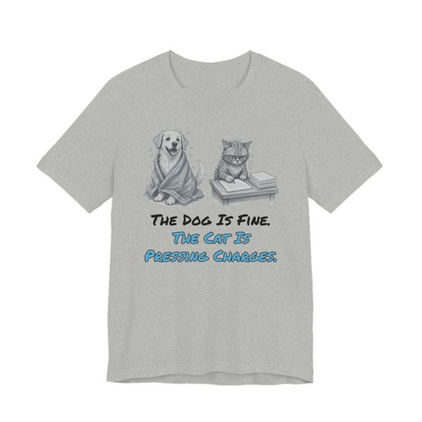 Athletic Heather t-shirt printed in full-color print with a full-color pencil drawing of a dog wrapped in a towel next to a cat with paperwork and the words “The Dog Is Fine. The Cat Is Pressing Charges.”