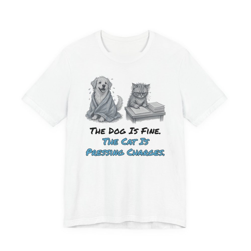 White t-shirt printed in full-color print with a full-color pencil drawing of a dog wrapped in a towel next to a cat with paperwork and the words “The Dog Is Fine. The Cat Is Pressing Charges.”