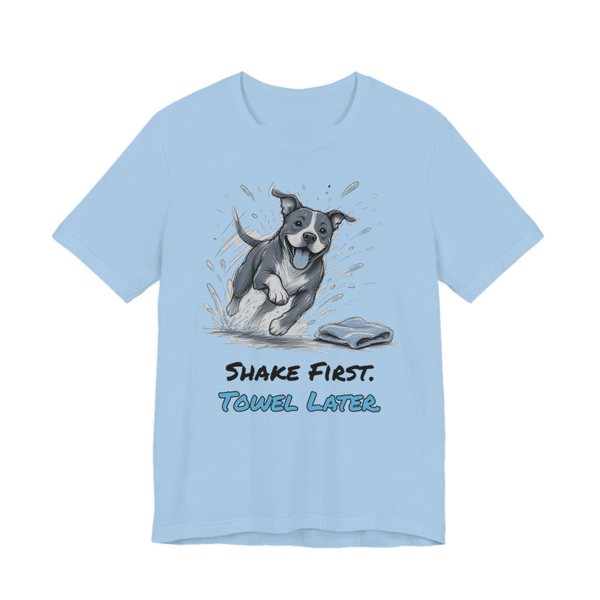 Baby Blue t-shirt printed in full-color print with a full-color pencil drawing of a pit bull shaking off water next to a towel and the words “Shake First. Towel Later.”