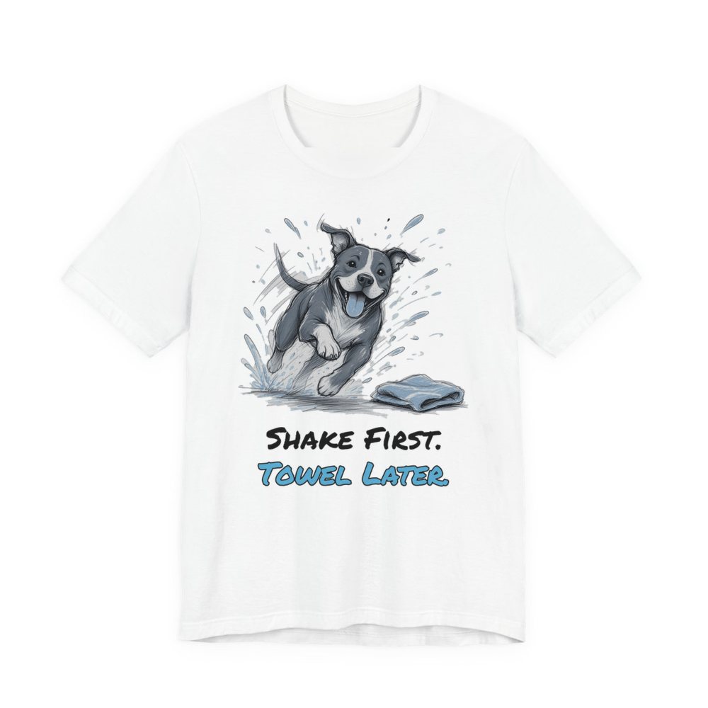 White t-shirt printed in full-color print with a full-color pencil drawing of a pit bull shaking off water next to a towel and the words “Shake First. Towel Later.”