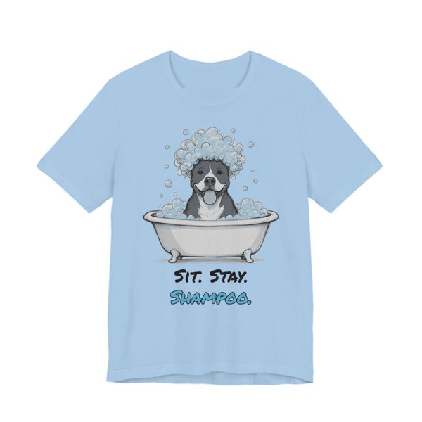 Baby Blue t-shirt printed in full-color print with a full-color pencil drawing of a pit bull with a head full of bubbles in a clawfoot tub and the words “Sit. Stay. Shampoo.”