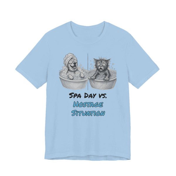 Baby Blue t-shirt printed in full-color print with a full-color pencil drawing of a happy dog in a bubble bath next to a frazzled wet cat and the words “Spa Day vs. Hostage Situation”