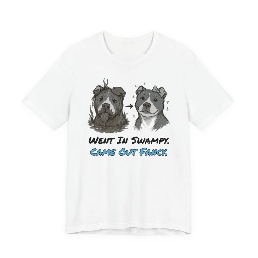 White t-shirt printed in full-color print with a full-color pencil drawing of a muddy pit bull next to the same pit bull freshly groomed and the words “Went In Swampy. Came Out Fancy.”