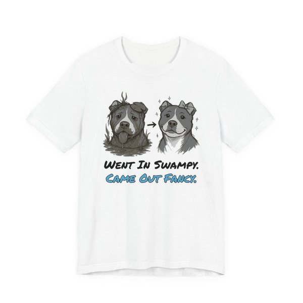 White t-shirt printed in full-color print with a full-color pencil drawing of a muddy pit bull next to the same pit bull freshly groomed and the words “Went In Swampy. Came Out Fancy.”