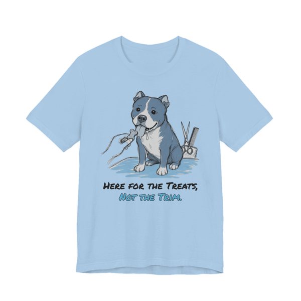 Baby Blue t-shirt printed in full-color print with a full-color pencil drawing of a pit bull reaching for a treat next to grooming scissors and the words “Here for the Treats, Not the Trim.”