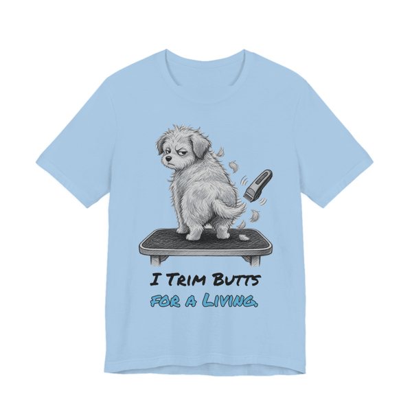 Baby Blue t-shirt printed in full-color print with a full-color pencil drawing of a fluffy dog on a grooming table and a pair of clippers and the words “I Trim Butts for a Living.”