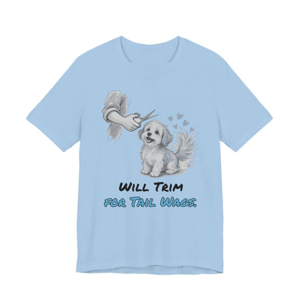 Baby Blue t-shirt printed in full-color print with a full-color pencil drawing of a small fluffy dog getting a trim, with little hearts and the words “Will Trim for Tail Wags.”