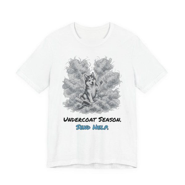 White t-shirt printed in full-color print with a full-color pencil drawing of a husky surrounded by a cloud of shed undercoat and the words “Undercoat Season. Send Help.”