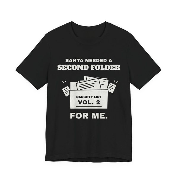 Black t-shirt printed with “Santa Needed a Second Folder for Me” with an overstuffed file box labeled “Naughty List Vol. 2”