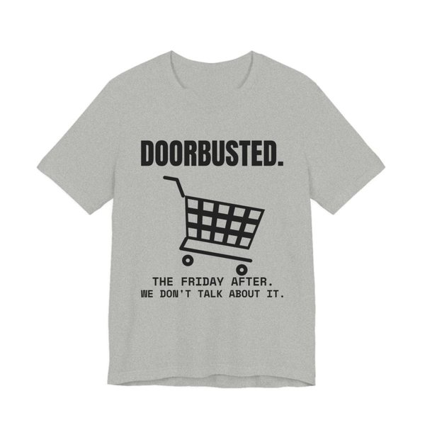 Athletic Heather t-shirt printed in dark ink with the word “Doorbusted.”