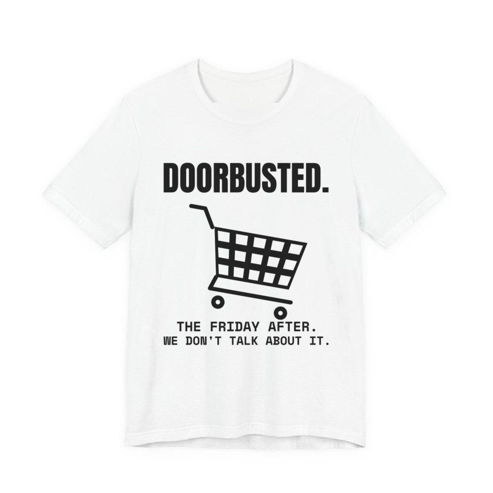 White t-shirt printed in dark ink with the word “Doorbusted.”