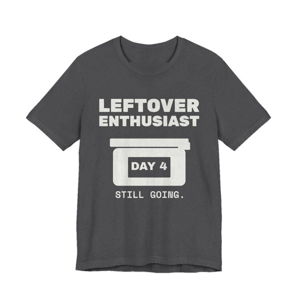 Dark Grey Heather t-shirt printed in off-white ink with a takeout-style leftovers container and the words “Leftover Enthusiast”