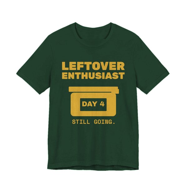 Forest t-shirt printed in gold ink with a takeout-style leftovers container and the words “Leftover Enthusiast”