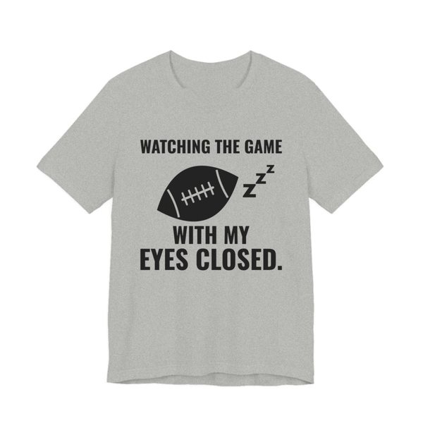 Athletic Heather t-shirt printed in dark ink with the words “Watching the Game With My Eyes Closed.”