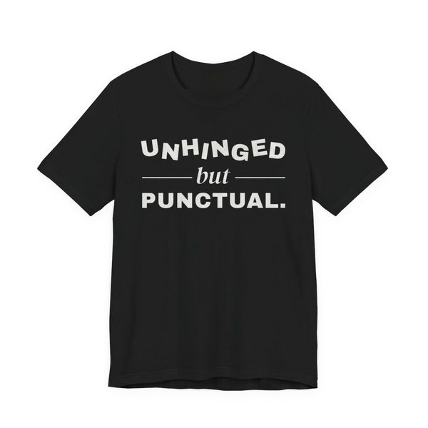 Black t-shirt printed with “Unhinged” in wobbly capitals, a calm italic “but”, and “Punctual.” squared away underneath