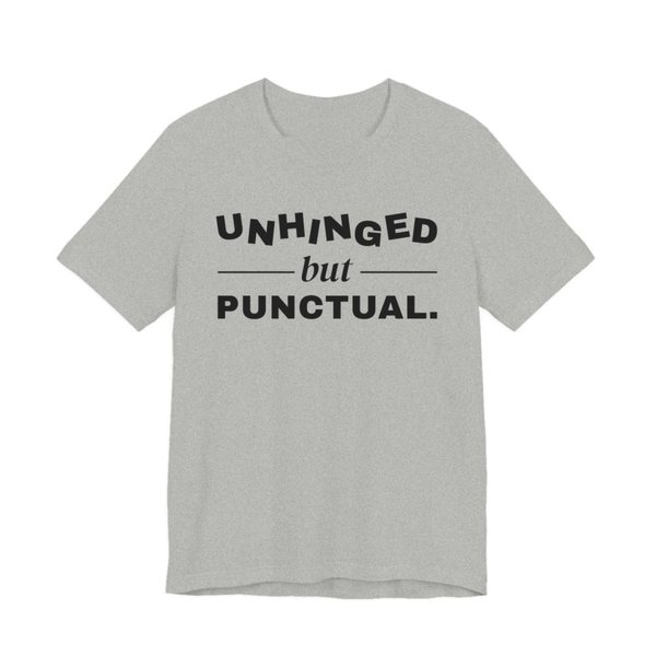 Athletic Heather t-shirt printed in dark ink with “Unhinged” in wobbly capitals, a calm italic “but”, and “Punctual.” squared away underneath