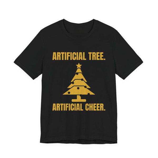 Black t-shirt printed in gold ink with a Christmas tree and the words “Artificial Tree. Artificial Cheer.”