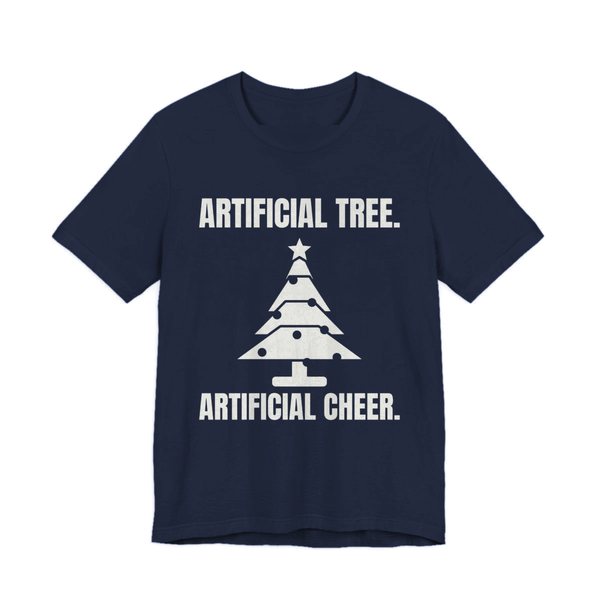 Navy t-shirt printed in off-white ink with a Christmas tree and the words “Artificial Tree. Artificial Cheer.”