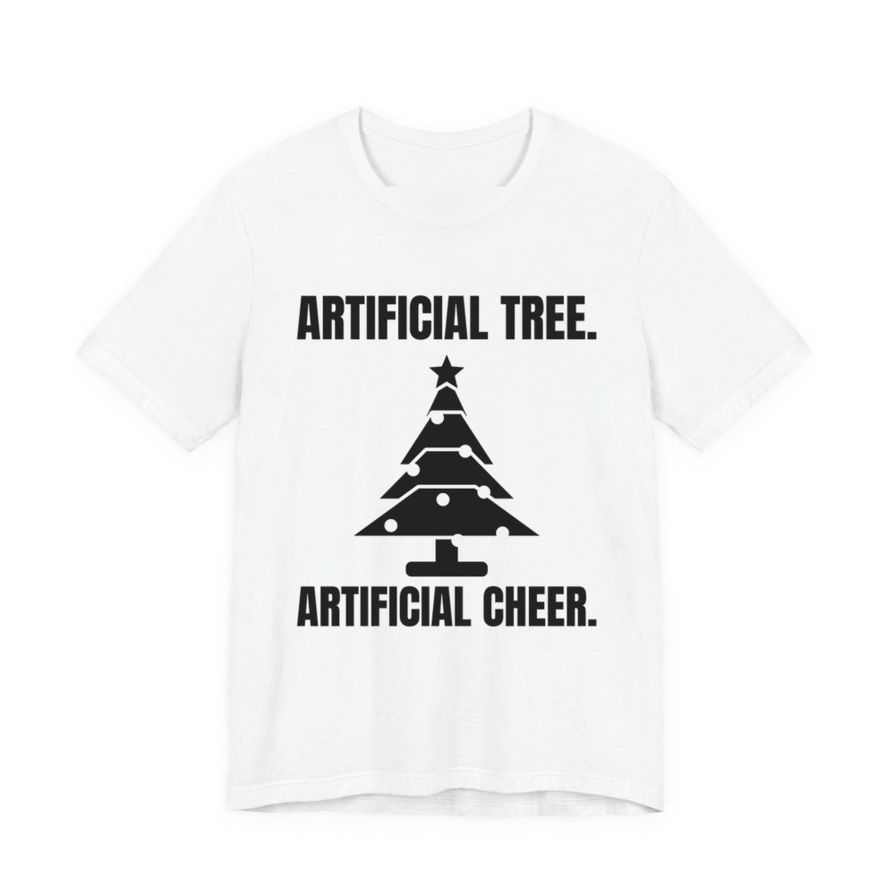 White t-shirt printed in dark ink with a Christmas tree and the words “Artificial Tree. Artificial Cheer.”