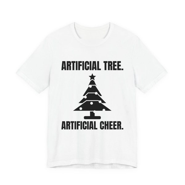 White t-shirt printed in dark ink with a Christmas tree and the words “Artificial Tree. Artificial Cheer.”