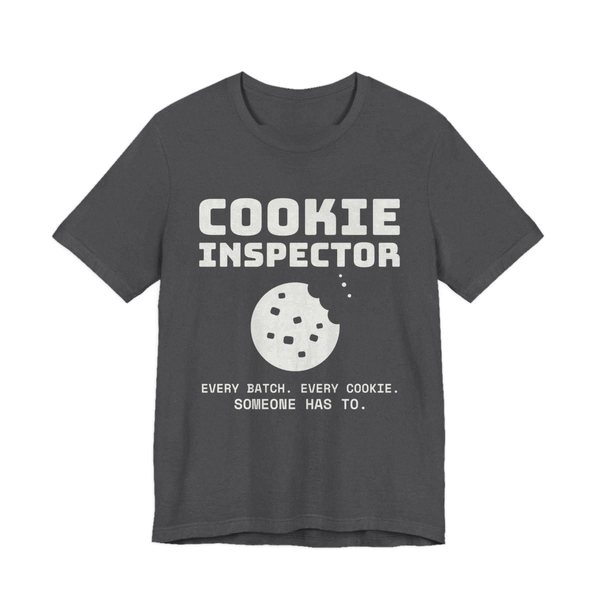 Dark Grey Heather t-shirt printed in off-white ink with a bitten cookie and the words “Cookie Inspector. Every batch. Every cookie. Someone has to.”