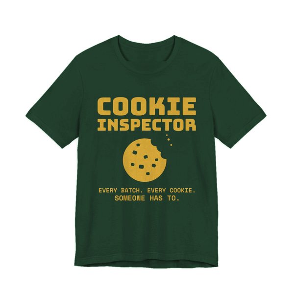 Forest t-shirt printed in gold ink with a bitten cookie and the words “Cookie Inspector. Every batch. Every cookie. Someone has to.”
