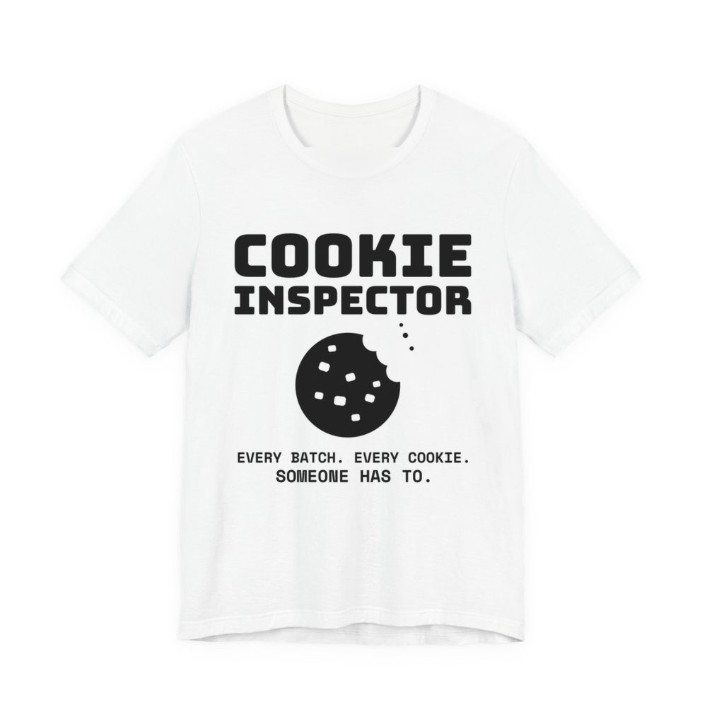 White t-shirt printed in dark ink with a bitten cookie and the words “Cookie Inspector. Every batch. Every cookie. Someone has to.”
