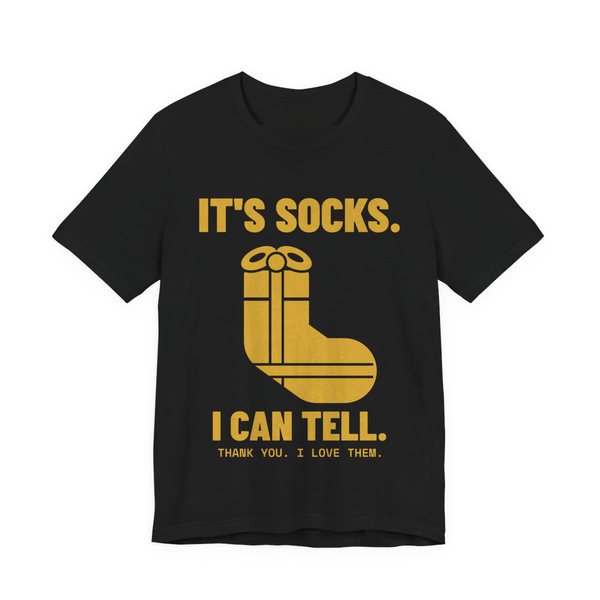 Black t-shirt printed in gold ink with a sock-shaped wrapped present and the words “It's Socks. I Can Tell. Thank you. I love them.”