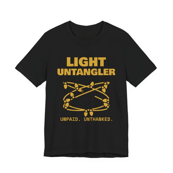 Black t-shirt printed in gold ink with a hopelessly tangled string of Christmas lights and the words “Light Untangler. Unpaid. Unthanked.”