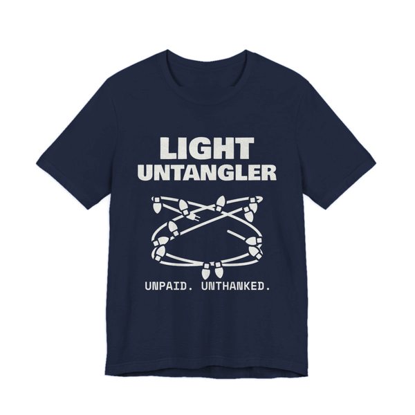 Navy t-shirt printed in off-white ink with a hopelessly tangled string of Christmas lights and the words “Light Untangler. Unpaid. Unthanked.”