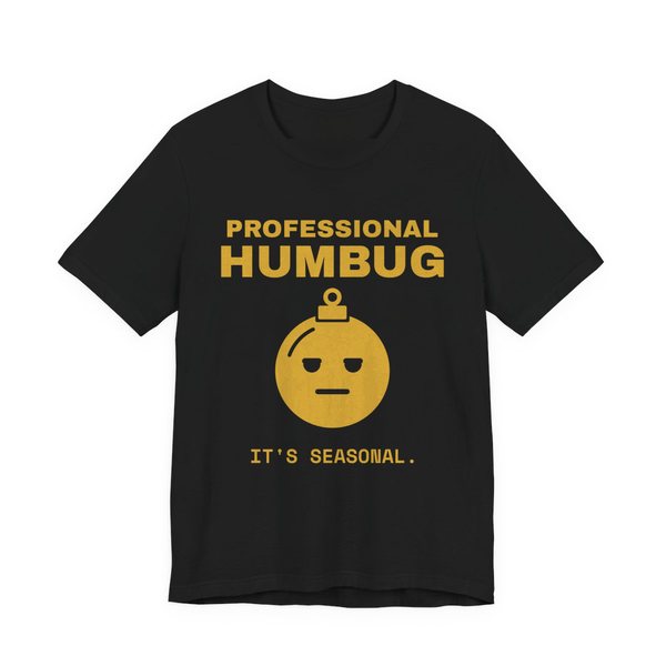 Black t-shirt printed in gold ink with an unimpressed ornament face and the words “Professional Humbug. It's Seasonal.”