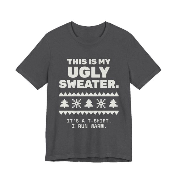 Dark Grey Heather t-shirt printed in off-white ink with a pixel-knit sweater pattern and the words “This Is My Ugly Sweater. It's a T-shirt. I run warm.”