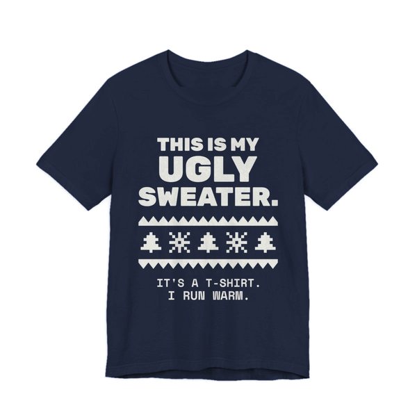 Navy t-shirt printed in off-white ink with a pixel-knit sweater pattern and the words “This Is My Ugly Sweater. It's a T-shirt. I run warm.”