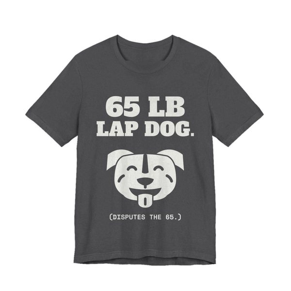 Dark Grey Heather t-shirt printed in off-white ink with a smiling pit bull face and the words “65 lb Lap Dog. (Disputes the 65.)”