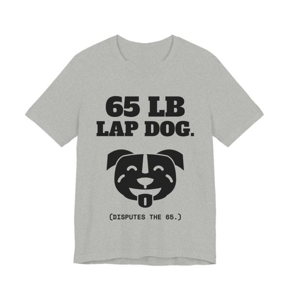 Athletic Heather t-shirt printed in dark ink with a smiling pit bull face and the words “65 lb Lap Dog. (Disputes the 65.)”