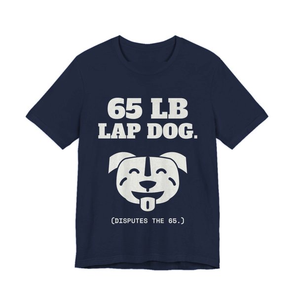 Navy t-shirt printed in off-white ink with a smiling pit bull face and the words “65 lb Lap Dog. (Disputes the 65.)”