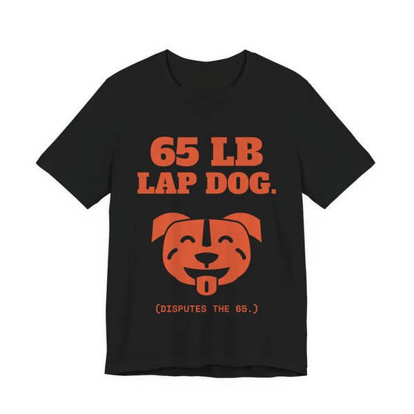 Black t-shirt printed in orange ink with a smiling pit bull face and the words “65 lb Lap Dog. (Disputes the 65.)”