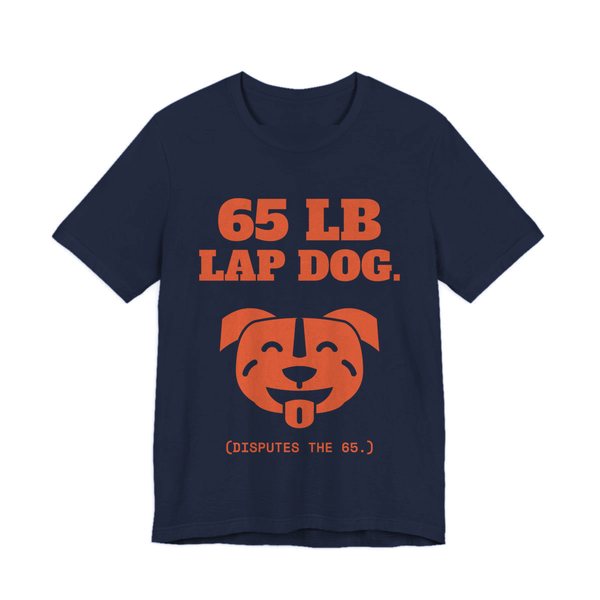 Navy t-shirt printed in orange ink with a smiling pit bull face and the words “65 lb Lap Dog. (Disputes the 65.)”
